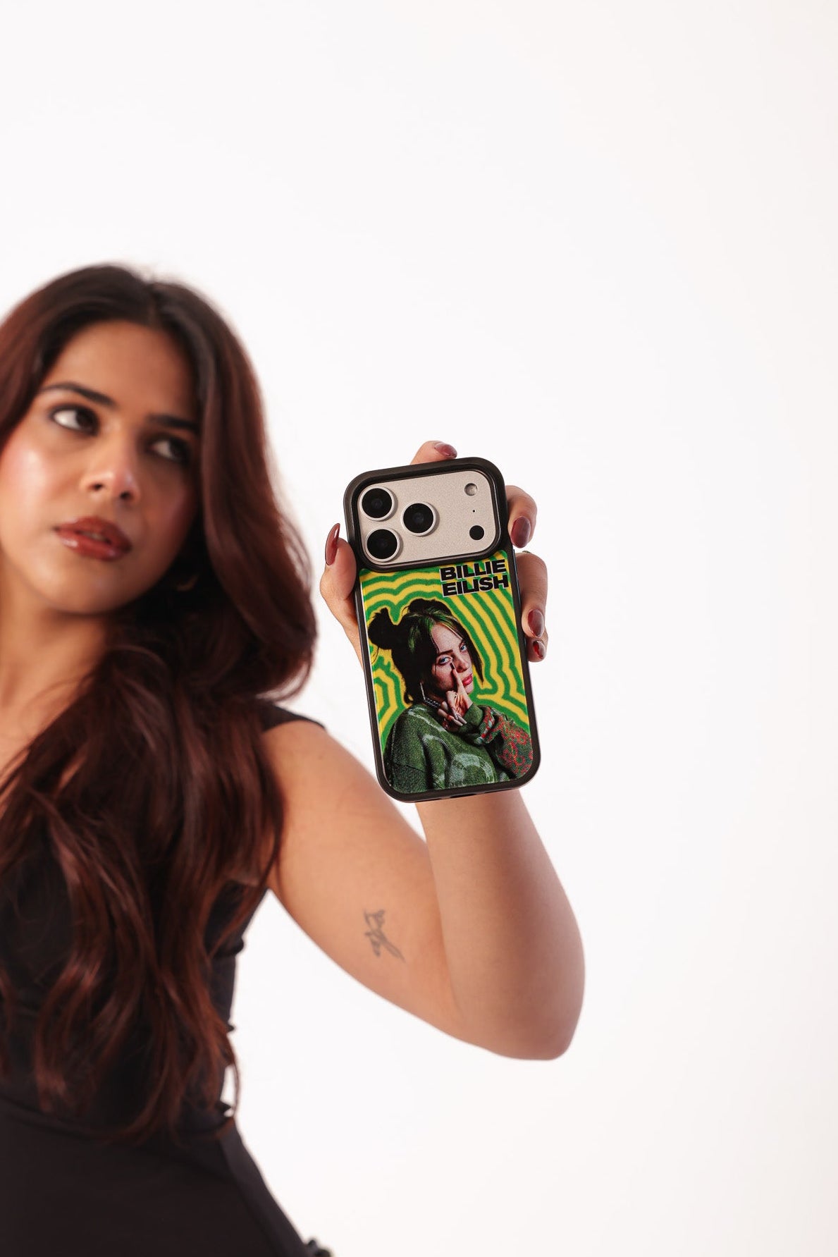 Woman holding a phone case with a graphic design on a white background